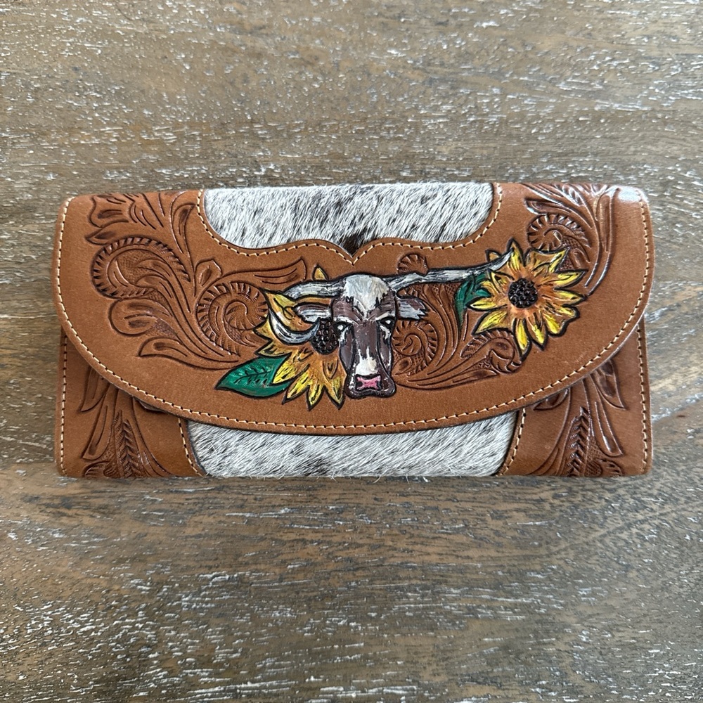 Leather wallet with detailed tooling, designs, and cowhide